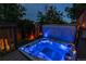 Inviting hot tub with glowing blue lights on a wooden deck at twilight at 16291 E 7Th Dr, Aurora, CO 80011