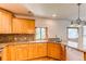 Spacious kitchen with wooden cabinets, granite countertops, and stainless steel appliances at 16291 E 7Th Dr, Aurora, CO 80011
