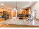 Modern kitchen with granite countertops, stainless steel appliances, and a breakfast bar island at 16291 E 7Th Dr, Aurora, CO 80011