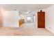 Open-concept living space with neutral carpet and a view into the adjacent kitchen and dining area at 16291 E 7Th Dr, Aurora, CO 80011