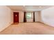 Spacious living room featuring neutral carpet, a large window, and a traditional front door at 16291 E 7Th Dr, Aurora, CO 80011