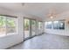Bright sun room with tile flooring, multiple windows, and access to the outdoors at 16291 E 7Th Dr, Aurora, CO 80011