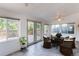 Inviting sunroom with tile floor, multiple windows, and access to a deck at 16291 E 7Th Dr, Aurora, CO 80011