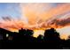 Dramatic sunset with bright colors over the neighborhood behind the home at 16291 E 7Th Dr, Aurora, CO 80011