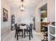 Open dining area with a modern chandelier and Beatles poster on the wall at 7770 W 38Th Ave # 207, Wheat Ridge, CO 80033