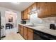 Kitchen featuring wooden cabinets, stainless steel sink, and modern appliances at 7770 W 38Th Ave # 207, Wheat Ridge, CO 80033