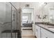 Bright bathroom with a glass-enclosed shower and double sink vanity at 12820 Inca St, Westminster, CO 80234