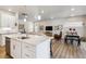 Open living space featuring a large kitchen island, living room, and dining area creating an inviting atmosphere at 12820 Inca St, Westminster, CO 80234