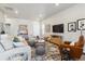 Bright and airy living room featuring a comfortable sofa, stylish rug, and ample natural light for a welcoming ambiance at 12820 Inca St, Westminster, CO 80234