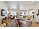 Inviting living room featuring a comfortable sofa, stylish furniture, and a seamless flow to the dining and kitchen areas at 12820 Inca St, Westminster, CO 80234