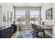 Bright home office featuring a large window, a spacious desk, and comfortable seating, ideal for a productive workspace at 12820 Inca St, Westminster, CO 80234