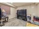 Carpeted basement media room with large television, storage and vintage table at 2544 S Fundy Cir, Aurora, CO 80013