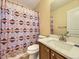 Bathroom boasts a unique shower curtain and single sink vanity with a neutral-toned countertop at 2544 S Fundy Cir, Aurora, CO 80013