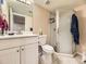 Bathroom features a vanity with sink, toilet, and glass shower enclosure at 2544 S Fundy Cir, Aurora, CO 80013