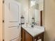 Charming bathroom boasts a single sink vanity with a decorative mirror and white marble countertop at 2544 S Fundy Cir, Aurora, CO 80013