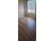 Bright bedroom with wood-look flooring and window with blinds providing natural light at 2544 S Fundy Cir, Aurora, CO 80013