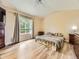 Cozy bedroom featuring a large window, vaulted ceilings, and light-colored wood flooring at 2544 S Fundy Cir, Aurora, CO 80013