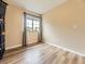 Cozy bedroom with hardwood floors features neutral-toned walls and ample natural light at 2544 S Fundy Cir, Aurora, CO 80013