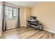Bright bedroom with wood-style flooring, large window, and neutral walls at 2544 S Fundy Cir, Aurora, CO 80013