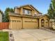 Inviting home featuring a three-car garage and charming front porch at 2544 S Fundy Cir, Aurora, CO 80013
