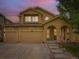 Inviting two-story home with three-car garage and covered porch, perfect for outdoor relaxation and curb appeal at 2544 S Fundy Cir, Aurora, CO 80013