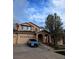 Charming two-story home with a three car garage and covered front porch with large tree at 2544 S Fundy Cir, Aurora, CO 80013