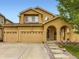 Inviting two-story home with three-car garage and covered porch, perfect for outdoor relaxation and curb appeal at 2544 S Fundy Cir, Aurora, CO 80013