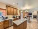 Modern kitchen with stainless steel appliances, island, and a view into the adjacent living space at 2544 S Fundy Cir, Aurora, CO 80013