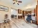Open-concept living room with ceiling fan, stylish floors, and seamless flow into the modern kitchen area at 2544 S Fundy Cir, Aurora, CO 80013