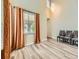 Bright living room with high ceilings, elegant chandelier, large windows, and stylish laminate flooring at 2544 S Fundy Cir, Aurora, CO 80013