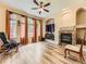 Comfortable living room features a fireplace, ceiling fan, and abundant natural light at 2544 S Fundy Cir, Aurora, CO 80013