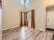 Sun-filled living room boasts wood-style floors, neutral-toned walls, and orange-colored curtains at 2544 S Fundy Cir, Aurora, CO 80013