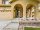 Welcoming covered porch with arched entry, stone accents, and multi-car garage, enhancing curb appeal at 2544 S Fundy Cir, Aurora, CO 80013