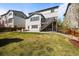 Spacious backyard featuring a well-maintained lawn, patio, and two-story home at 11046 Pastel Pt, Parker, CO 80134
