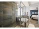 A modern bathroom features a stand up shower, and soaking tub with views to main bedroom at 11046 Pastel Pt, Parker, CO 80134