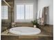 A modern bathroom features a stand up shower, soaking tub, and a view to outside at 11046 Pastel Pt, Parker, CO 80134