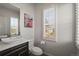 Bright half-bathroom featuring modern vanity and fixtures at 11046 Pastel Pt, Parker, CO 80134