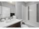 Clean bathroom with mosaic tile backsplash, decorative sink, and combined shower and tub at 11046 Pastel Pt, Parker, CO 80134