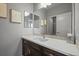 Stylish bathroom with a white countertop, dark wood cabinetry, and decorative mirror at 11046 Pastel Pt, Parker, CO 80134