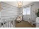 Bright, cheerful Bedroom featuring custom wallpaper, rocking toys, and natural light from shutters at 11046 Pastel Pt, Parker, CO 80134