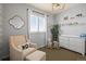 Charming Bedroom with rocking chair, decor, and white dresser with a changing station at 11046 Pastel Pt, Parker, CO 80134