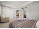 Bedroom featuring a closet with sliding doors, a barn door to the bathroom, and neutral tones at 11046 Pastel Pt, Parker, CO 80134