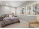 Bedroom features natural light, a queen bed, and calming grey walls at 11046 Pastel Pt, Parker, CO 80134