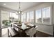 Bright dining room with hardwood floors, stylish chandelier, and sliding doors to deck at 11046 Pastel Pt, Parker, CO 80134