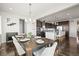 Open-concept dining room showcasing hardwood floors and seamless flow to modern kitchen at 11046 Pastel Pt, Parker, CO 80134