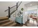 Inviting entryway with staircase, a charming vanity, and hardwood floors leading into the living area at 11046 Pastel Pt, Parker, CO 80134
