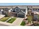 Charming two-story home with a well-manicured front yard and a spacious driveway leading to an attached two-car garage at 11046 Pastel Pt, Parker, CO 80134