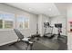Brightly lit home gym with large windows, weight bench, and updated equipment at 11046 Pastel Pt, Parker, CO 80134