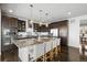 Gourmet kitchen featuring a large island with seating, ample cabinet space, and stainless steel appliances at 11046 Pastel Pt, Parker, CO 80134