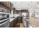 Well-equipped kitchen boasting modern appliances, sleek cabinetry, and a spacious granite countertop island at 11046 Pastel Pt, Parker, CO 80134
